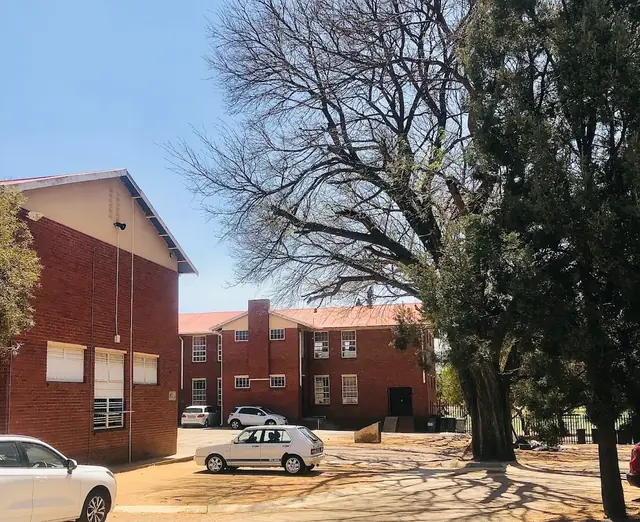 Red-brick buildings and trees on the Clapham High School campus in Queenswood, Pretoria