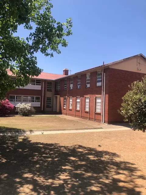 Clapham High School building and lawn on a sunny day