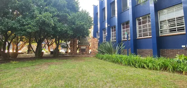 Blue classroom building and garden at Hoërskool Langenhoven