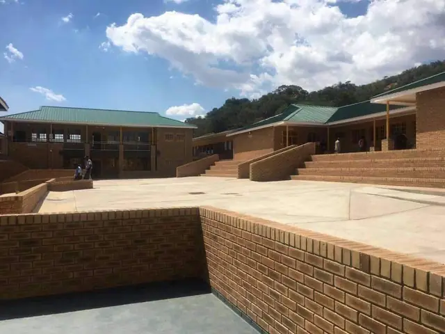 Brick courtyard and steps between Marobathotha Secondary School classroom blocks