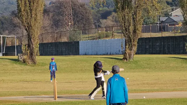 Learners playing cricket on the Queens High School field