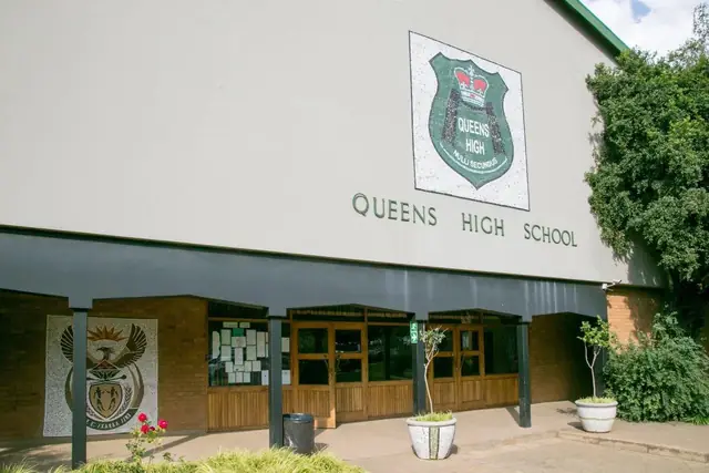Queens High School hall with the school crest