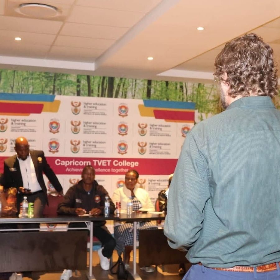 Panel Discussion at Capricorn TVET College Event Officials seated on a panel at a Capricorn TVET College event with Department of Higher Education branding