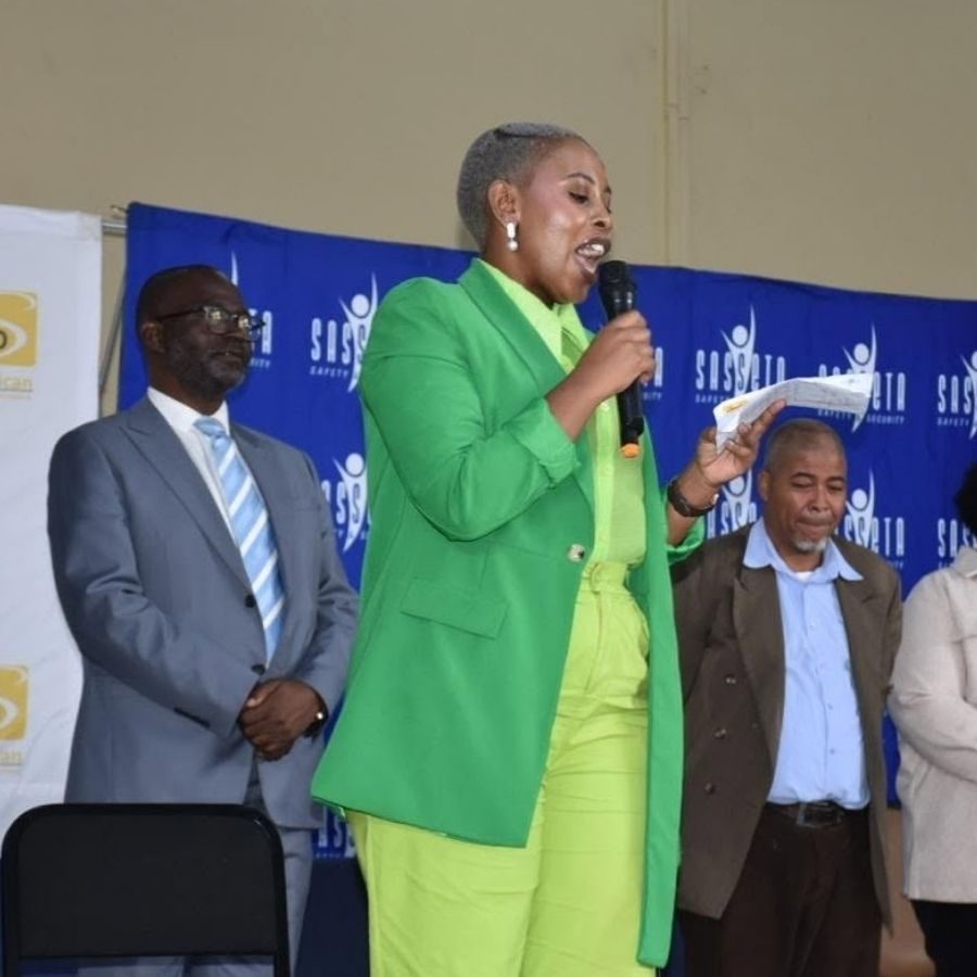 A speaker addresses attendees on stage at a Central Johannesburg College event backed by SASSETA branding