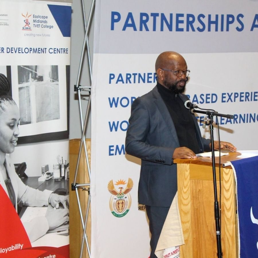 Speaker at Podium During Partnerships Event A speaker addresses the audience from a podium at an Eastcape Midlands TVET College partnerships event