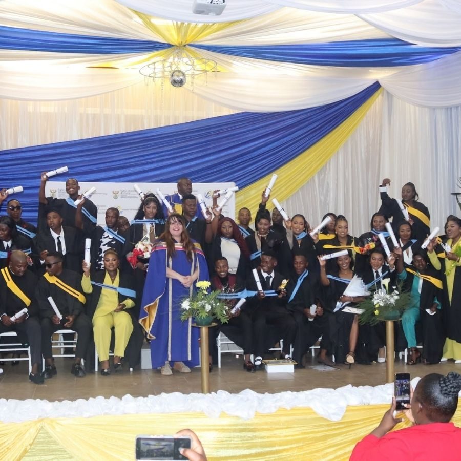 Graduation Ceremony Group Photo Large group of Ehlanzeni TVET College graduates raising certificates on stage at a graduation ceremony, Mpumalanga