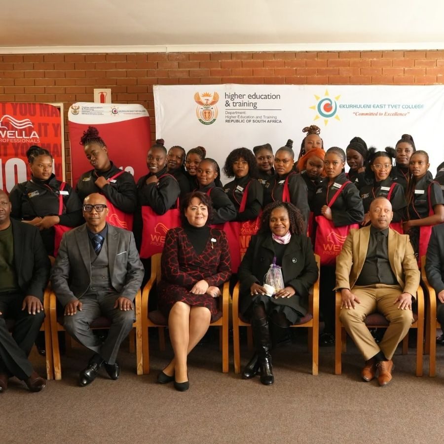Ekurhuleni East TVET College hairdressing students and officials posing with Wella Professionals branded bags