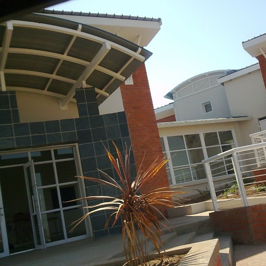 Ingwe TVET College Modern Campus Building Exterior view of a modern Ingwe TVET College campus building with brick pillars and curved roof detailing.