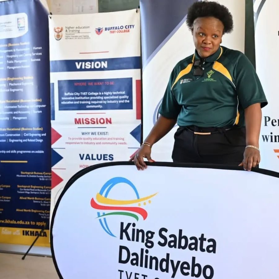 King Sabata Dalindyebo TVET College Representative at Expo King Sabata Dalindyebo TVET College representative standing behind the college's branded sign at a multi-college exhibition.