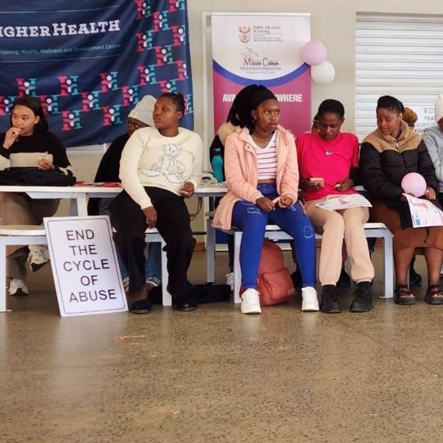 Majuba TVET College Students at Gender-Based Violence Awareness Talk Majuba TVET College students seated beside a sign reading "End the Cycle of Abuse" at a Higher Health awareness campaign