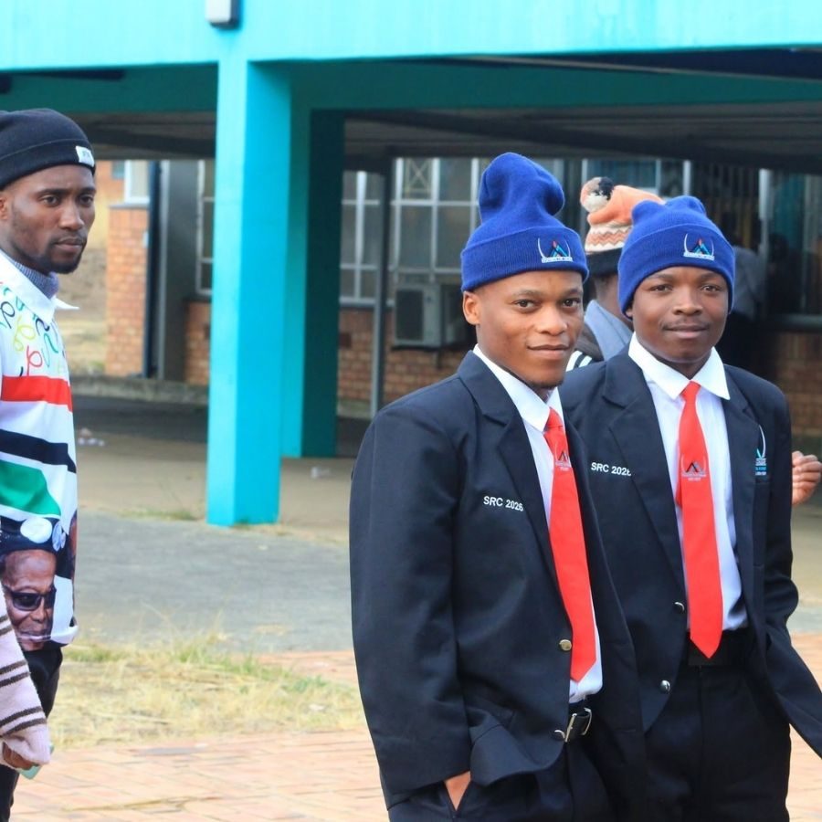 Mnambithi TVET College SRC 2026 Members in Blazers Two Mnambithi TVET College SRC 2026 members in navy blazers, red ties and blue beanies standing on campus
