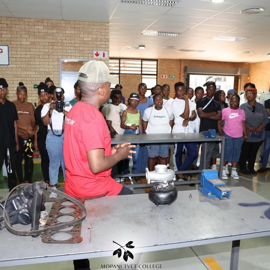 Mopani South East TVET College Motor Mechanics Demonstration Instructor demonstrating an engine turbocharger component to a group of students in a Mopani South East TVET College mechanics workshop