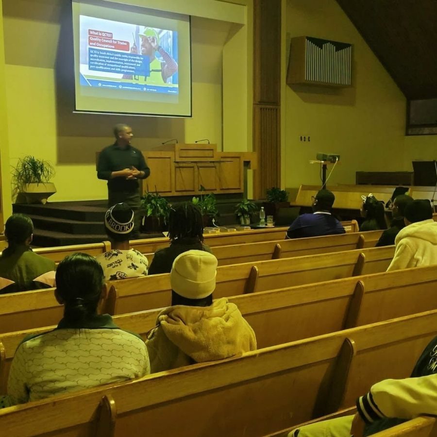 Northlink College QCTO Information Talk A speaker presents information on the QCTO to students seated in pews at a Northlink College outreach talk.