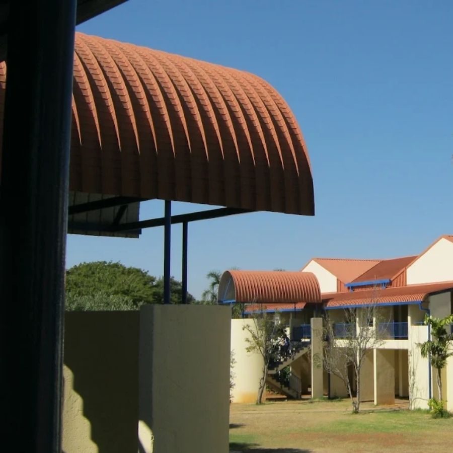 Taletso TVET College Campus Buildings Taletso TVET College campus buildings with distinctive curved orange roofs and a courtyard walkway.