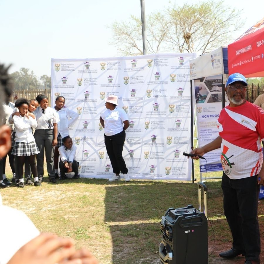 Tshwane North TVET College Campus Recruitment Talk A Tshwane North TVET College representative speaks with a microphone to learners at an outdoor recruitment and marketing event