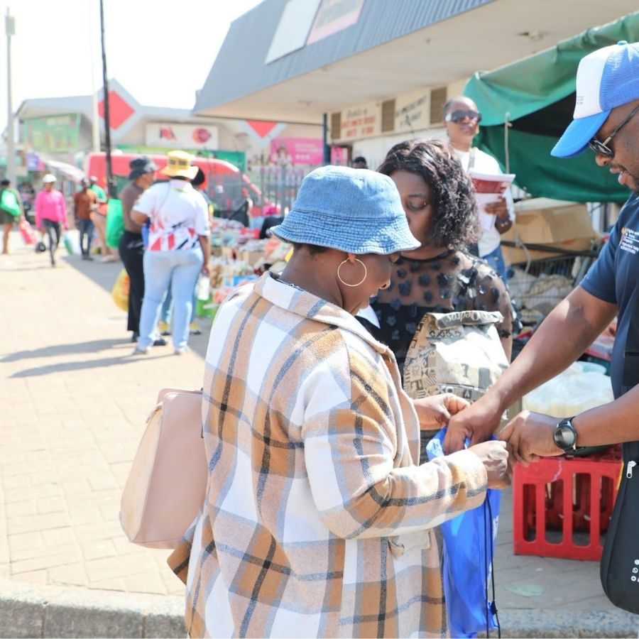Tshwane North TVET College Outreach at Street Market A Tshwane North TVET College staff member hands course information to shoppers at a busy street market stall