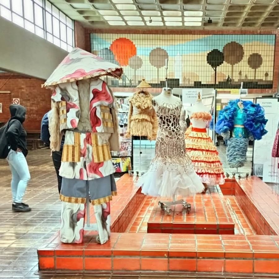 Elaborate handmade garments on mannequins displayed at an Umgungundlovu TVET College fashion and apparel design exhibition