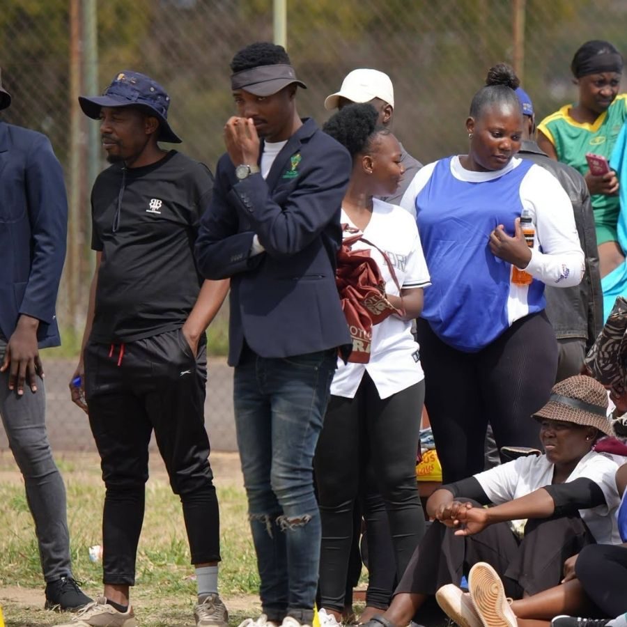 Vhembe TVET College Spectators at Sports Day Vhembe TVET College students and staff standing and seated pitch-side watching a sports day event