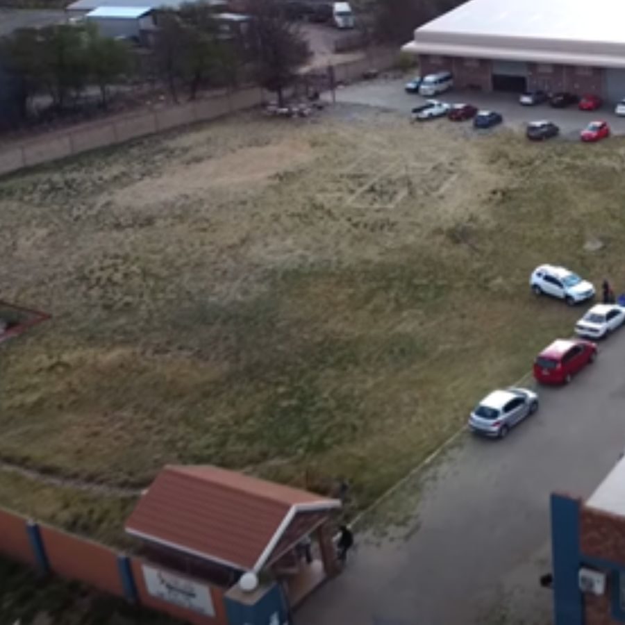 Vuselela TVET College Parking and Grounds Aerial View Aerial view of the Vuselela TVET College parking area, entrance gate, and open grounds