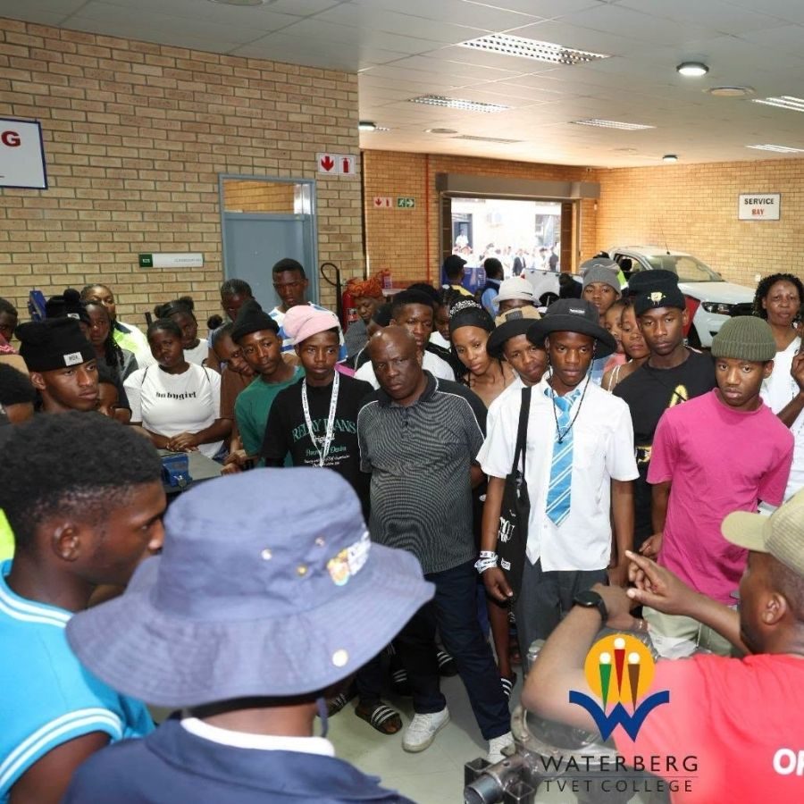 Waterberg TVET College Campus Tour Crowd A large crowd of learners tours the Waterberg TVET College automotive workshop and service bay during an open day