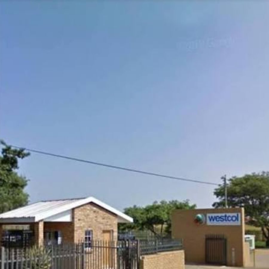 Western TVET College Campus Building and Sky Distant view of a small Westcol Western TVET College building with brick house and open sky above the campus grounds