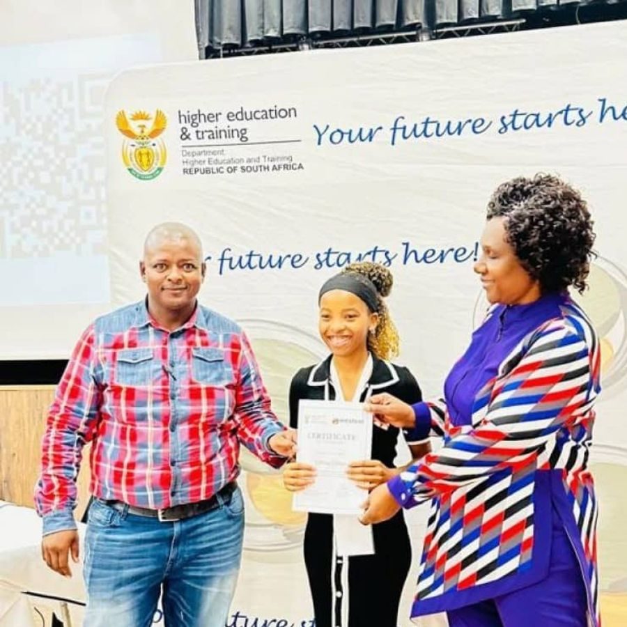 Western TVET College Certificate Presentation Ceremony A Western TVET College student receives a certificate from staff on stage in front of a "Your future starts here" banner