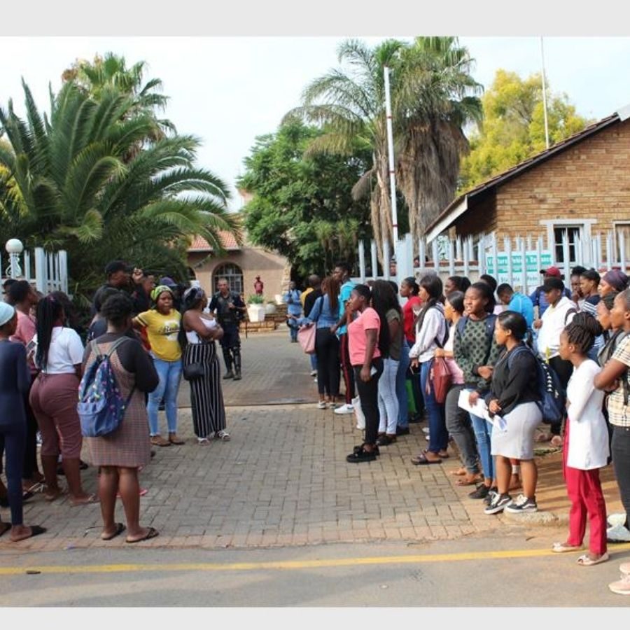 Western TVET College Students Queue at Campus Gate A large group of Western TVET College students queue outside the campus gate on registration day